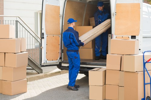 Removal van and moving team in West Brompton residential street