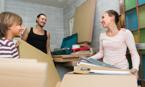 Professional movers carrying items from a West Brompton flat