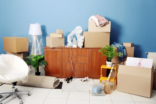 Trained moving staff wearing PPE while handling furniture